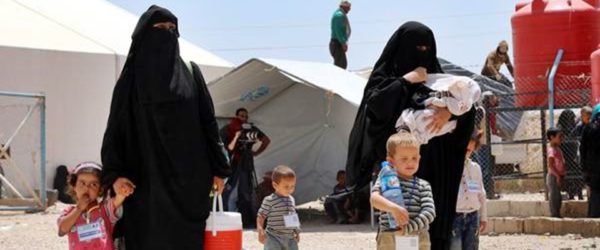epa07623503 Wives of Islamic state fighters (IS) walk with their children upon their deportation from the al-Hol camp for refugees in al-Hasakah governorate in northeastern Syria on 03 June 2019 (issued 04 June 2019).  According to media reports, the Kurdish authorities in northeast Syria are handing over 800 women and children all of them Syrian, including relatives of Islamic state fighters, to their families in the first such transfer from an overcrowded camp.  EPA/AHMED MARDNLI