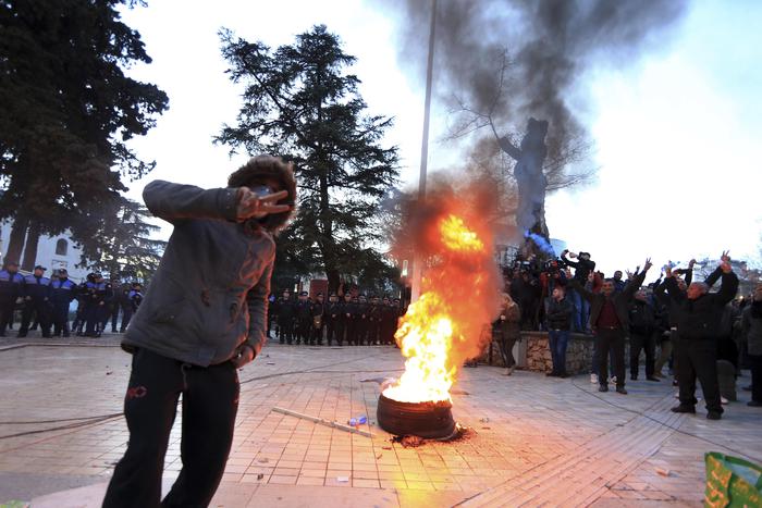 Protesters flash the V-victory sign during an antigovernment rally in Tirana, Tuesday, Feb. 26, 2019. Albanian opposition supporters have surrounded the parliament building and are demanding that the government resign, claiming it's corrupt and has links to organized crime. (ANSA/AP Photo/Hektor Pustina) [CopyrightNotice: Copyright 2019 The Associated Press. All rights reserved.]
