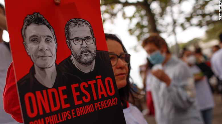 Brazilian actress Lucelia Santos takes holds a poster with the images of  British journalist Dom Phillips, left, and expert on indigenous affairs Bruno Araujo Pereira following their disappearance in the Amazon, during a protest in Copacabana beach, Rio de Janeiro, Brazil, Sunday, June 12, 2022. Federal Police and military forces are carrying out searches and investigations into the disappearance of Phillips and Pereira in the Javari Valley Indigenous territory, a remote area of the Amazon rainforest in Atalaia do Norte, Amazonas state. (AP Photo/Bruna Prado)